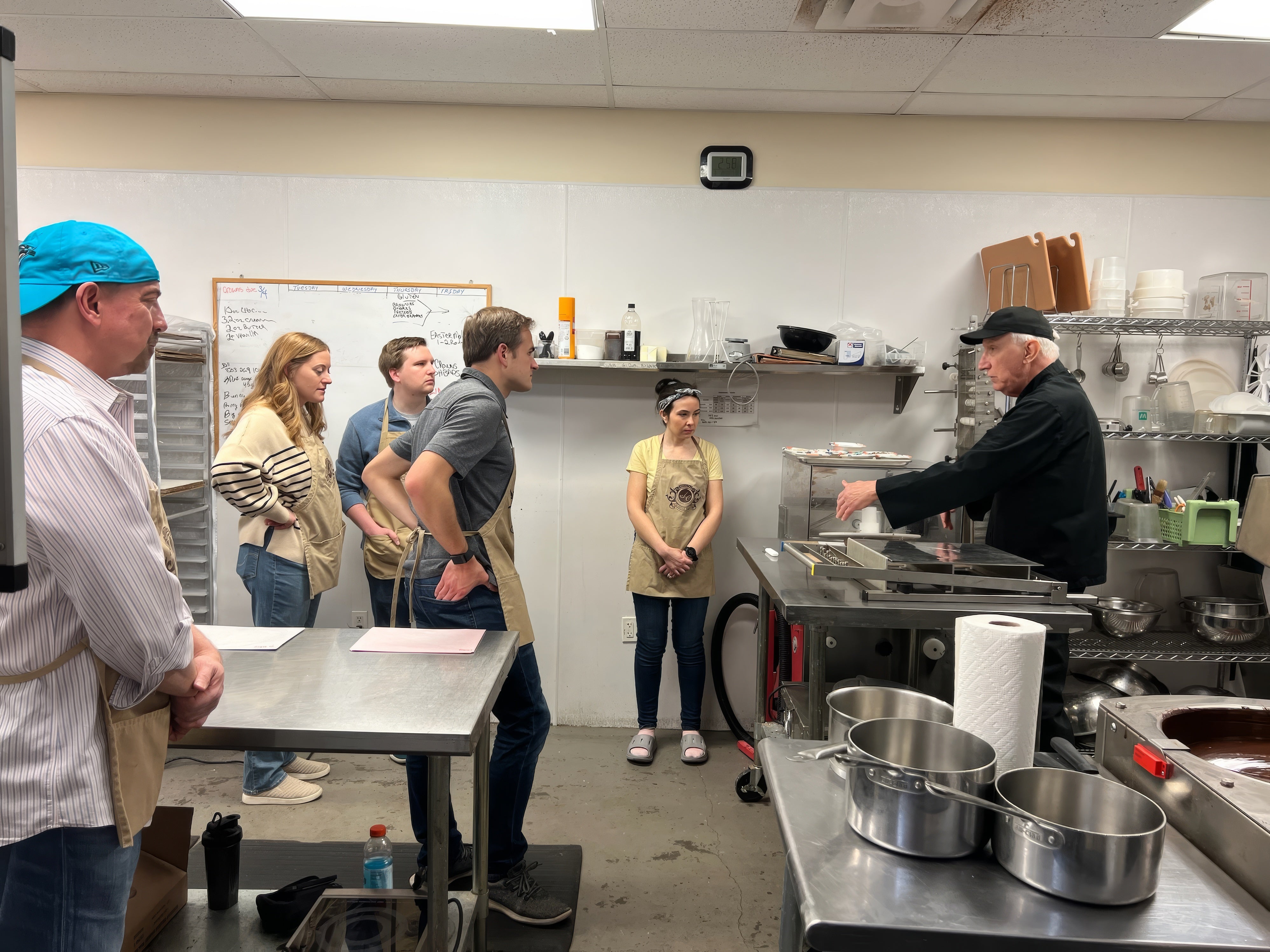 Happy participants showing off handmade chocolate truffles during a hands-on truffle-making class at The Secret Chocolatier in Charlotte, NC.
