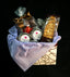 Tea & Chocolate Indulgence Kit — TSC chocolate truffles with brown ribbon, Moments In Tea Darjeeling Green and Rooibos Red Bush tins, biscotti, and a decorative red teapot ornament.