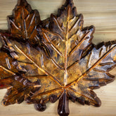 A dark chocolate maple leaf colored with autumn gold and orange colors. Rustic looking, edible.