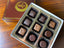 Caramel-Oh! 9-piece chocolate box with an assortment of dark and milk chocolate caramels in varied shapes.
