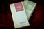 Two French Broad Chocolate single-origin bars — Peru 70% cacao and Costa Rica 80% cacao — in mint-blue and gold packaging on burgundy fabric.
