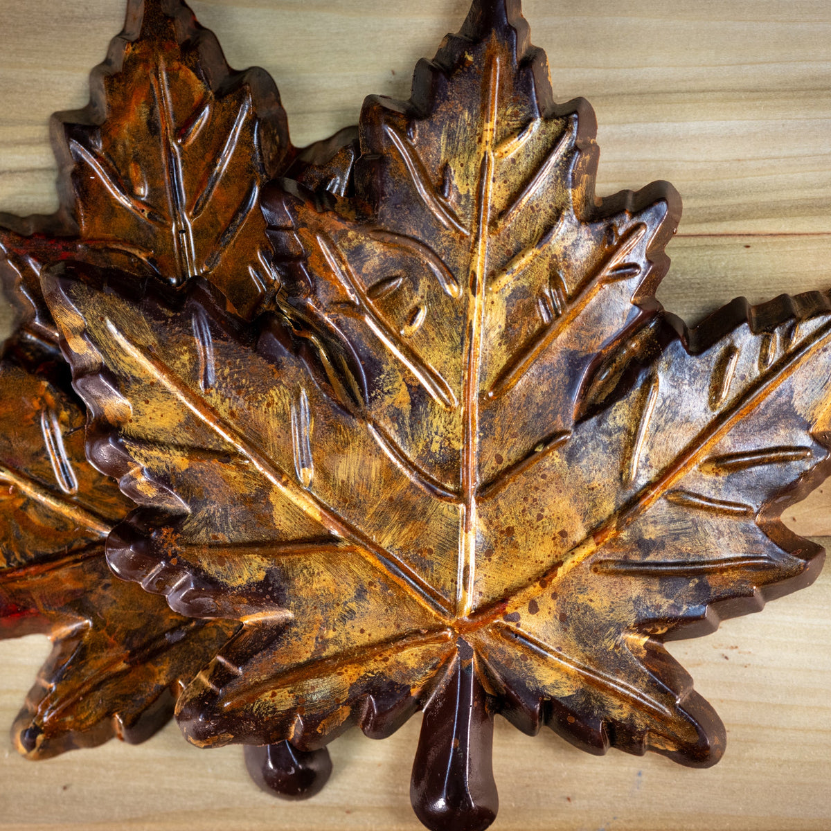 A dark chocolate maple leaf colored with autumn gold and orange colors. Rustic looking, edible. 