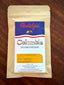 Nostalgia Chocolate Colombia 70% Dark Chocolate single-origin bar in a kraft-paper bag with a colorful label — Huila region, pomegranate and caramel tasting notes.