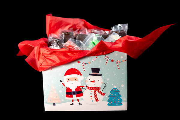 Brownie Pop Decorating Kit Christmas gift box — Santa-and-snowman illustrated box packed with brownie pops and supplies.