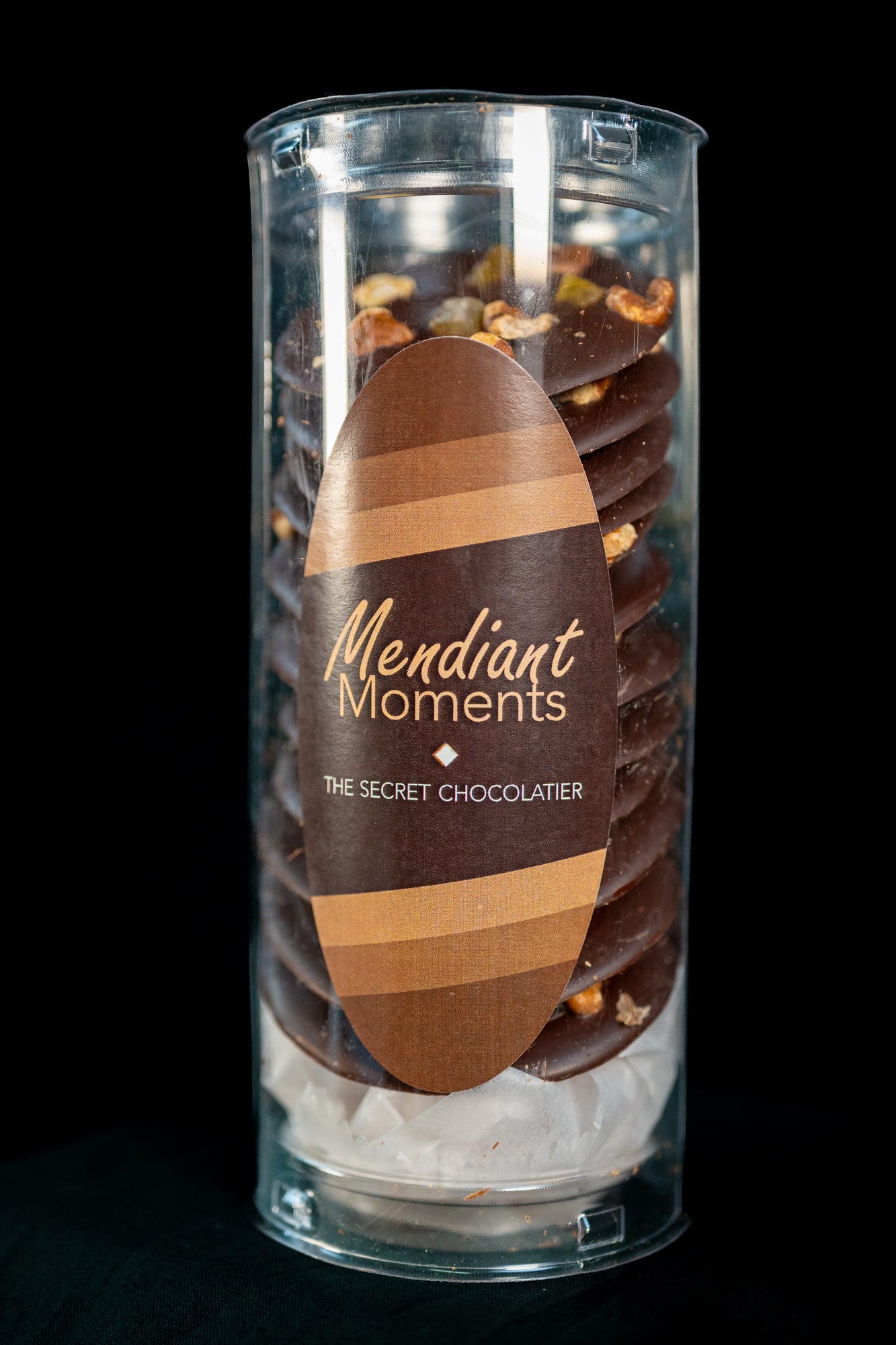 Mendiant moments, dark chocolate disks with orange peel and pecans
