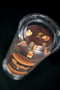 Mendiant moments, dark chocolate disks with orange peel and pecans, top down