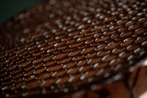 Macro view of the Chocolate Oblivion Torte's quenelle-patterned ganache surface.