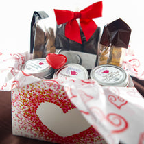 Tea & Chocolate Indulgence Kit Valentine's variant — heart-window box with chocolates, Moments In Tea tins, and a red heart ornament.