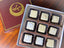 All About the White Chocolate 9-piece box — assortment of white chocolate truffles and bonbons with varied decorative pipings.