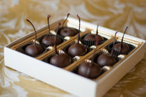 Valentine's Chocolate Cherries assortment in a gift box, each cherry coated in chocolate with the stem intact.