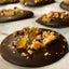 Walnut Orange Dark Chocolate Mendiant — round dark chocolate discs topped with chopped walnuts and candied orange peel.