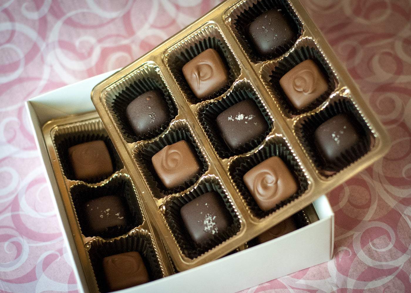 Valentine's Heart-Shaped Caramel Box close-up, the dark chocolate caramels and sea-salt finish visible through the heart window.