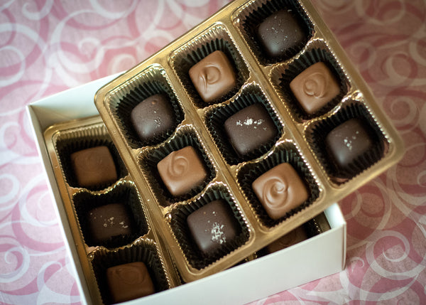 Valentine's Heart-Shaped Caramel Box close-up, the dark chocolate caramels and sea-salt finish visible through the heart window.