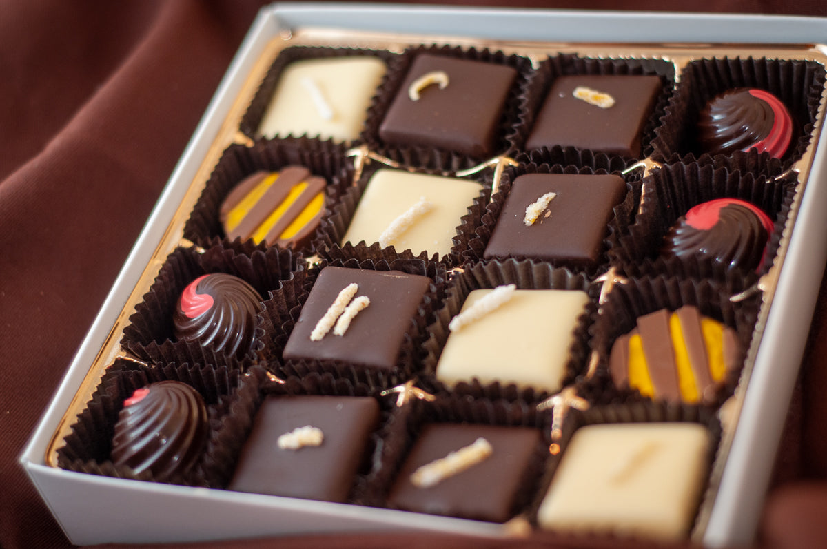 Fruitsy Tootsy 16-piece chocolate box — fruit-flavored bonbons with bright decorative accents in dark, milk, and white chocolate.