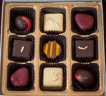 Overhead view of the Fruitsy Tootsy chocolate box with the full assortment of fruit-flavored bonbons.