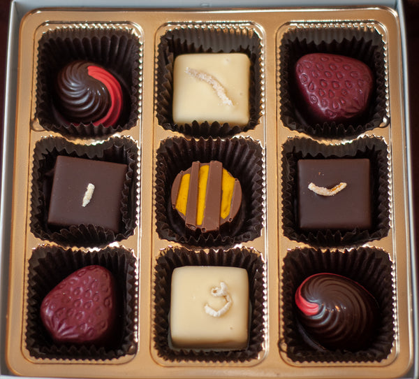 Overhead view of the Fruitsy Tootsy chocolate box with the full assortment of fruit-flavored bonbons.