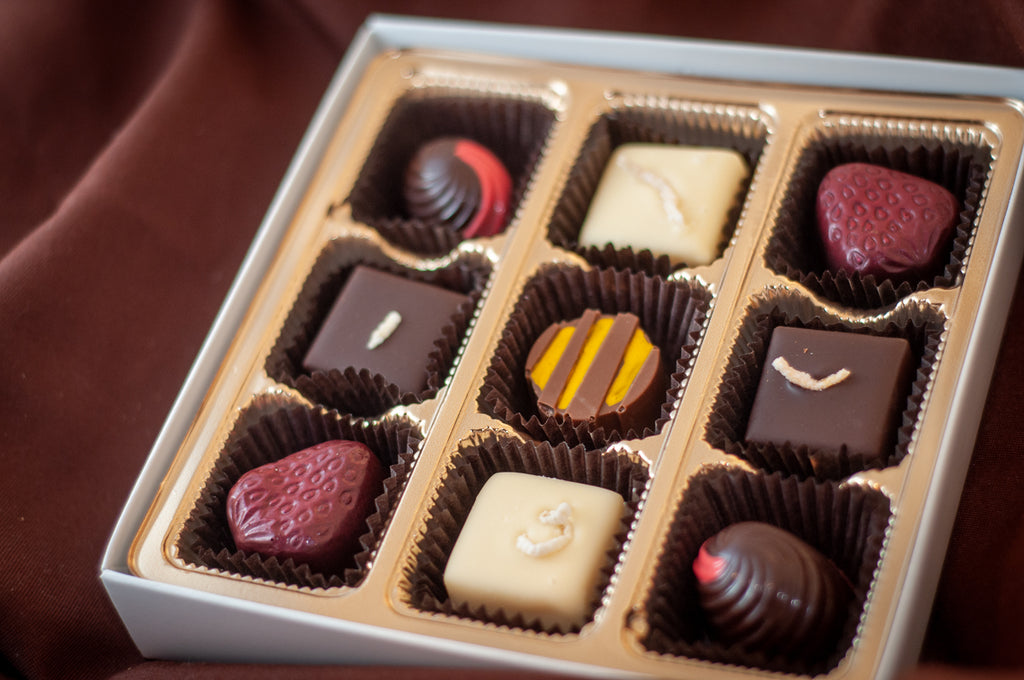 Fruitsy Tootsy bonbons in detail, each piece decorated to reflect a different fruit flavor.