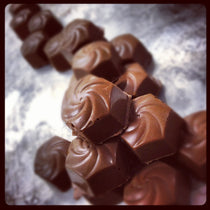 Stack of Cinnamon Roll Bon Bons in close detail, the piped chocolate swirl visible on each piece.