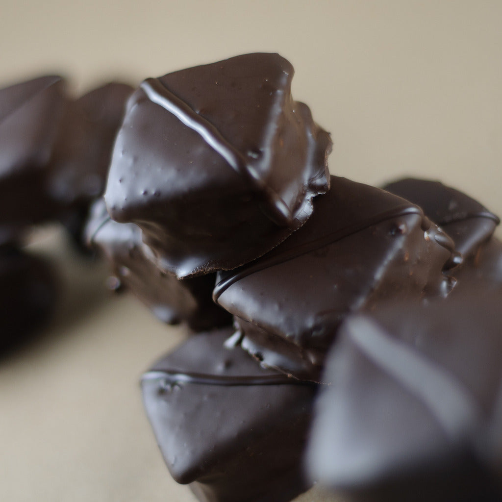Stack of Chocolate Marshmallows — dark chocolate enrobing each square marshmallow with visible drizzle from the dipping process.