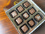 Nothing But Milk 9-piece chocolate box — milk chocolate truffles and bonbons with varied decorative pipings.