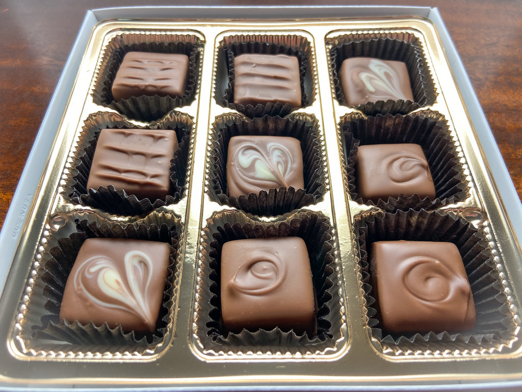 Close-up of Nothing But Milk chocolates showing the milk chocolate pieces and decorative ganache tops.