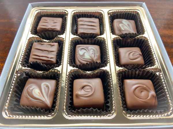 Close-up of Nothing But Milk chocolates showing the milk chocolate pieces and decorative ganache tops.