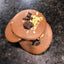 Peanut Pretzels Milk Chocolate Mendiant — milk chocolate discs topped with chocolate-coated peanut pretzels and crushed pretzel pieces.