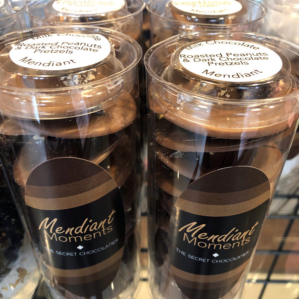 Stack of Peanut Pretzels Milk Chocolate Mendiants showing the pretzel-and-peanut topping on each milk chocolate disc.