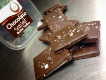 Sea Salt Chocolate Butter Toffee — dark chocolate-coated toffee slab finished with flaked sea salt.