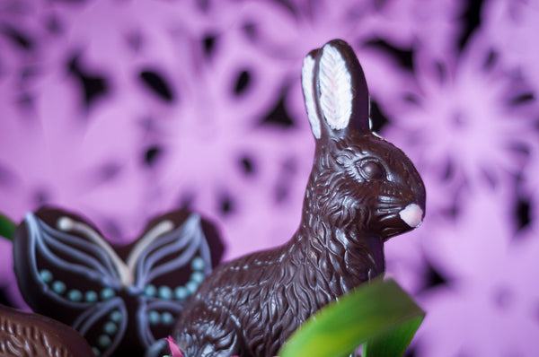 Close-up of the upright dark chocolate Easter bunny from the Small Chocolate Easter Basket, the textured fur and white inner ears in detail.
