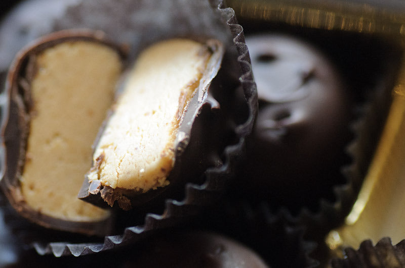 Peanut Butter Porcupines — close-up cross-section showing the smooth peanut butter filling inside a dark chocolate shell. Main image