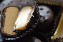Peanut Butter Porcupines — close-up cross-section showing the smooth peanut butter filling inside a dark chocolate shell.