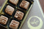 Milk Chocolate Truffles in a 6-piece box, each square truffle decorated with a caramel-colored ganache pattern.