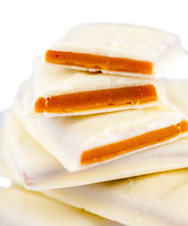 White Chocolate Cloister Honey Toffee broken into pieces, the buttery honey toffee enrobed in white chocolate.