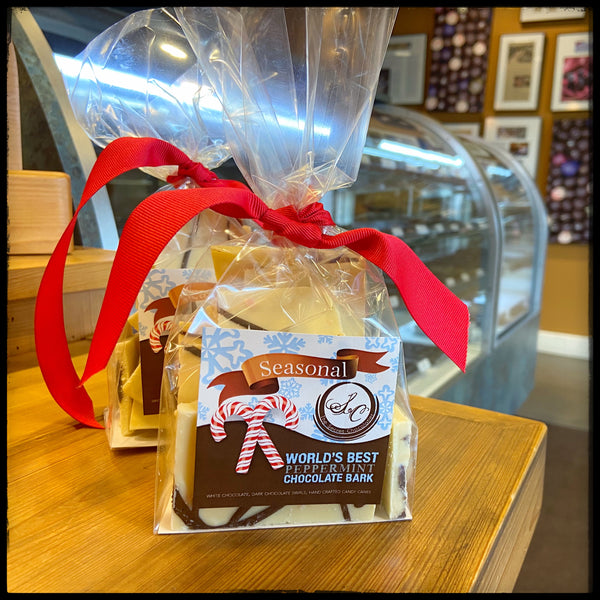 Chocolate Swirl Peppermint Bark in The Secret Chocolatier's Seasonal gift bag with red ribbon and World's Best Peppermint Chocolate Bark label.