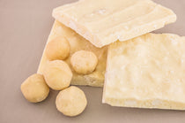 White Chocolate Macadamia Bark — squares of white chocolate bark with whole macadamia nuts shown alongside.